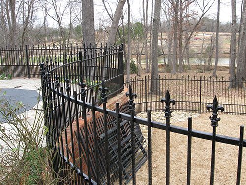 Carefully constructed curved fencing integrates with retaining wall and landscaping for a striking look.