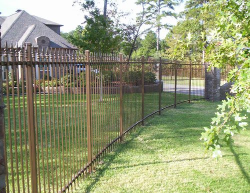 This bronze powder finished fence with a gentle curve produces a much different look than a traditional straight black fence.