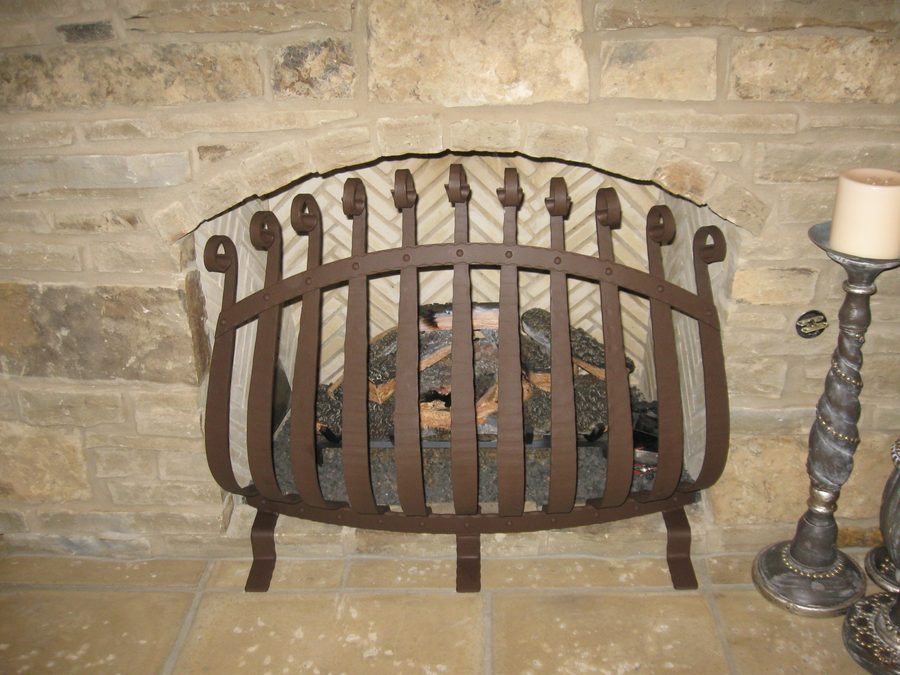 A bold, medieval-inspired metal design with curved vertical bars, riveted details, and decorative scroll accents for a strong yet stylish look.